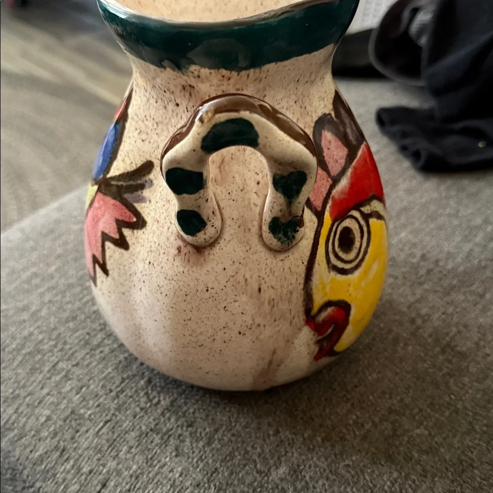 This is a vintage hand-painted ceramic pitcher 1976